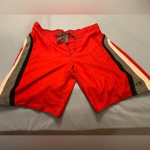 Two pair of men’s swim trunks. Both are size 36-38. Both have pockets. Both Red